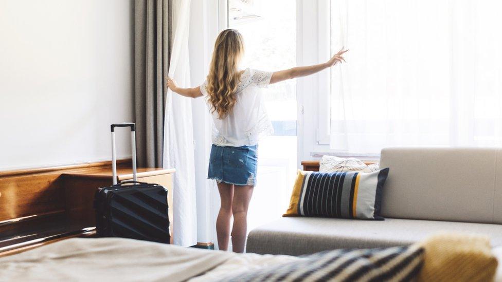 Woman in hotel room