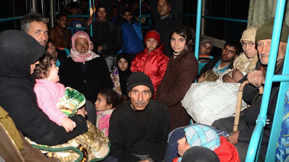 Syrian families are evacuated by bus through Sheikh Maqsud, a Kurdish-controlled enclave between the government-held west of Aleppo and the east, on November 27, 2016