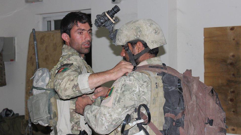 Afghan special forces checking their equipment as they prepare to launch a counter-offensive to regain control of Kunduz