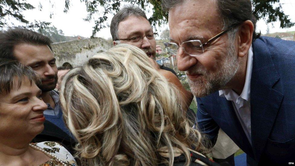 Spanish Prime Minister Mariano Rajoy (R) greets supporters during an electoral campaign event in Asturias, northern Spain, 16 December