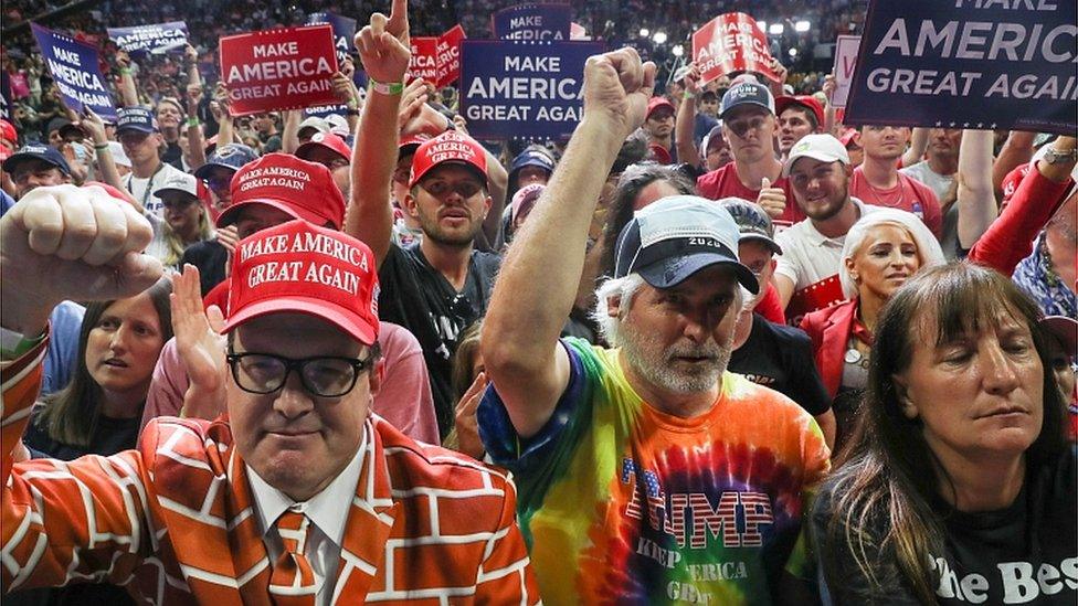 Supporters hold up signs during a campaign rally for President Donald Trump at the BOK Center, June 20, 2020 in Tulsa, Oklahoma