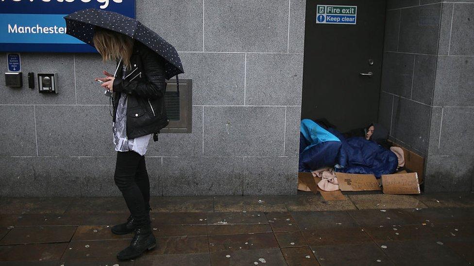 Homeless man sleeping in Manchester doorway