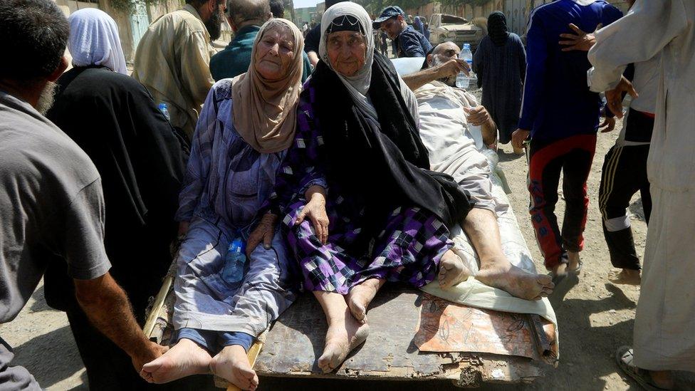 Displaced Iraqi people who fled from clashes head to safer territory while riding in a cart, in western Mosul, Iraq, June 3, 2017