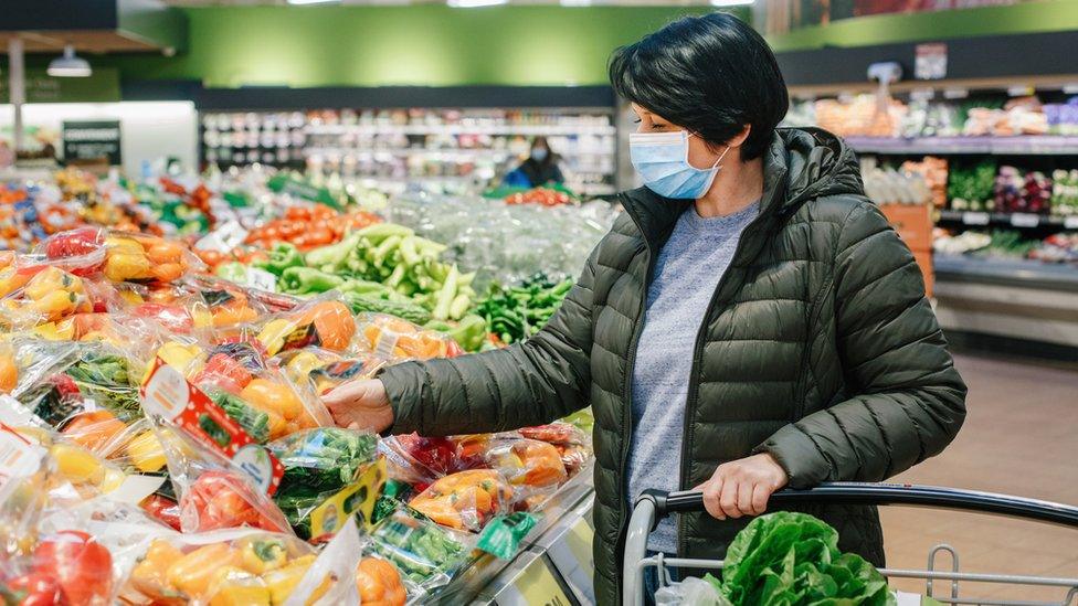 Woman wears a mask in a supermarket