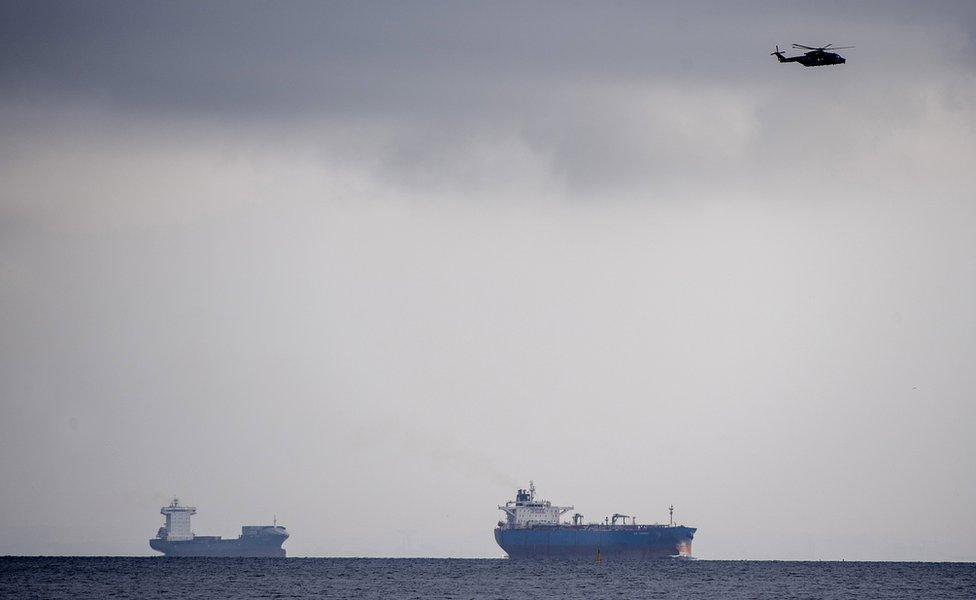 Helicopters search Copenhagen harbour for a missing submarine