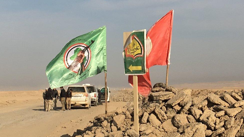 Shia paramilitary flags by the side of the road from Mosul to Raqqa, now under their control