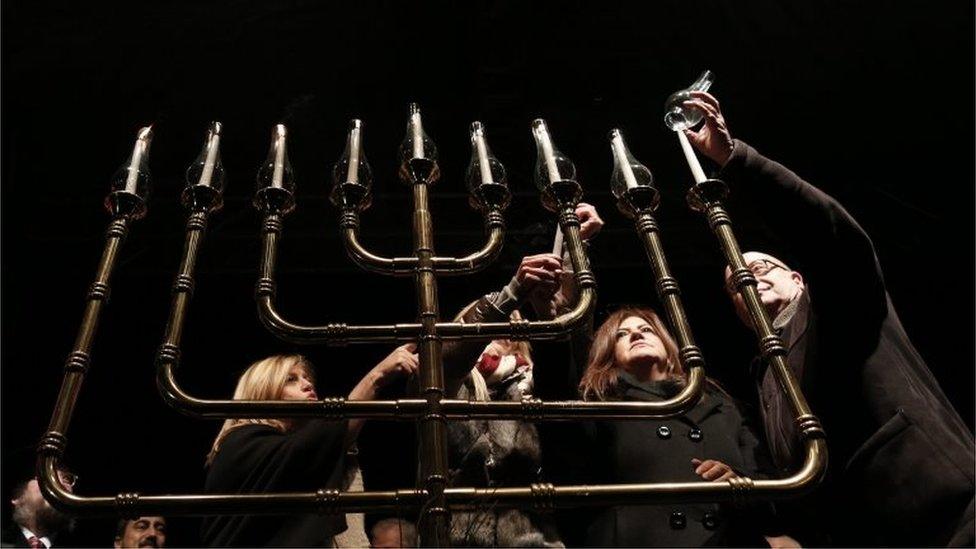 Turkish-Jewish people light a chanukiah to celebrate the Jewish festival of Hanukkah in Istanbul, Turkey, 13 December 2015.