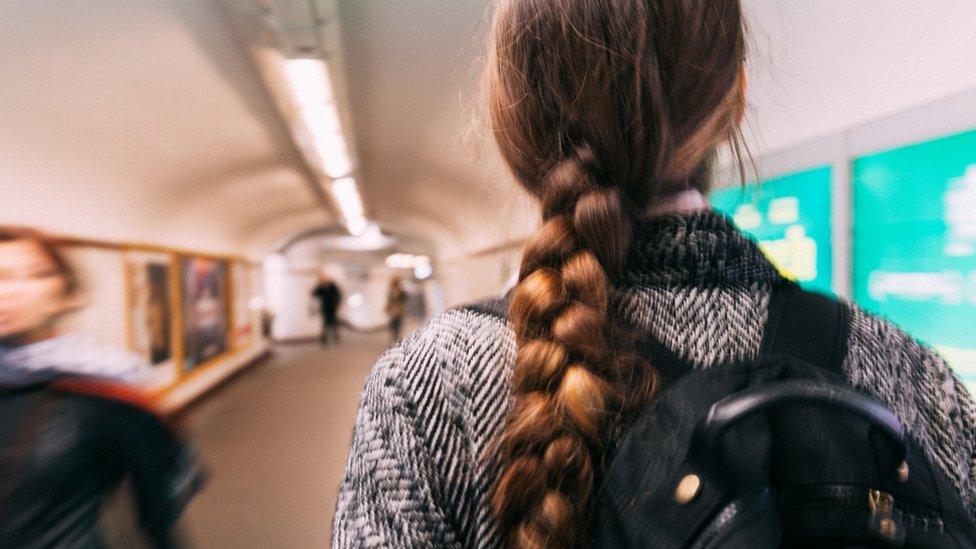 Back of person walking through underground station