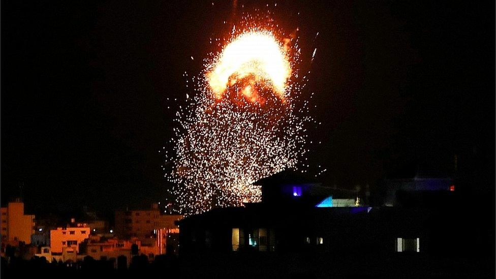 Flames rise above a building during Israeli air strikes in Gaza City May 17, 2021