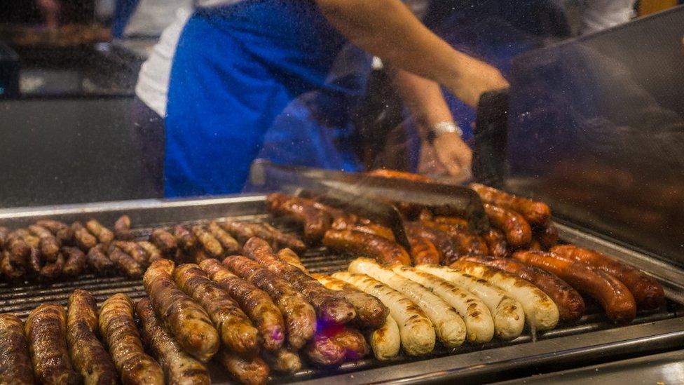 Sausages being cooked on a grill