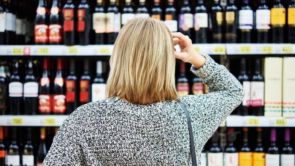 Woman shopping in off licence