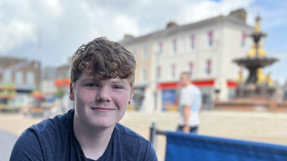 Noel Carson with town fountain in the background