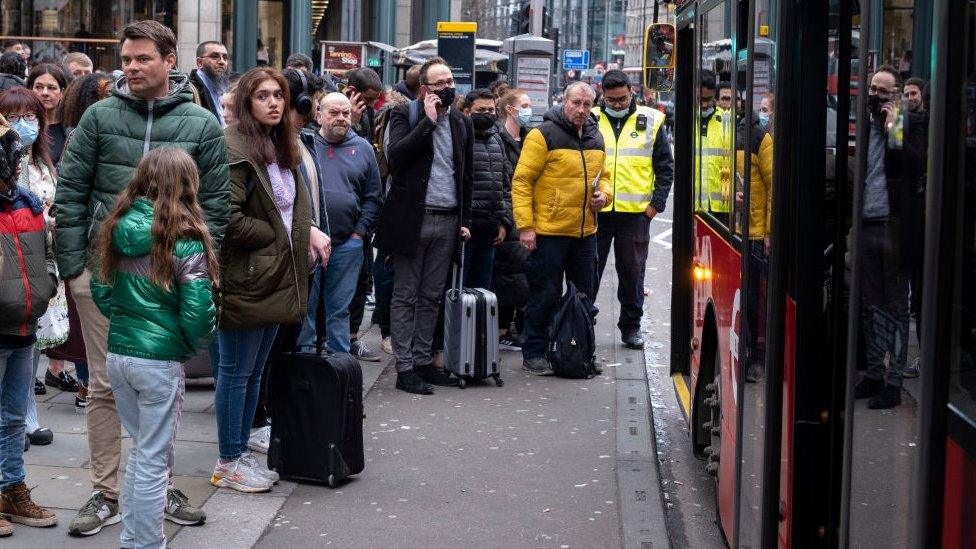 People queuing for a bus