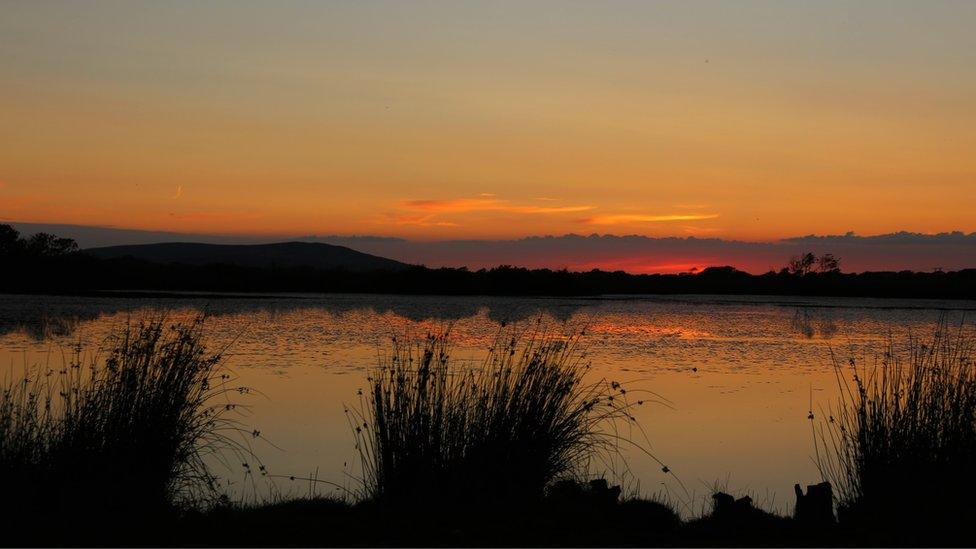 Sunset at Cefn Bryn on Gower peninsula photographed by Neil Bartlett from Clydach, Swansea.