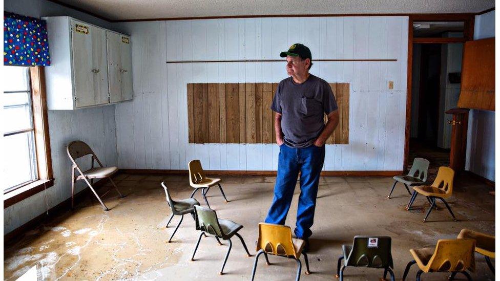 Ronnie Carroll, 70, a mission worker from Roberstdale, Alabama, stands in a children's bible study room in the First Baptist Church in Baker. "It's heartbreaking... I believe a tornado is better because you just lose everything at once, and it's gone, it takes it with it. A flood, they can see it. They can touch it, and they want to fix it but can't."