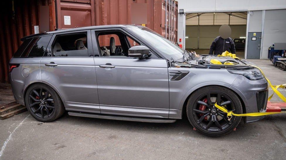 Range Rover Sport being pulled out of a shipping container