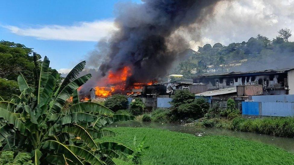 Flames rise from buildings in Honiara's Chinatown on November 26, 2021