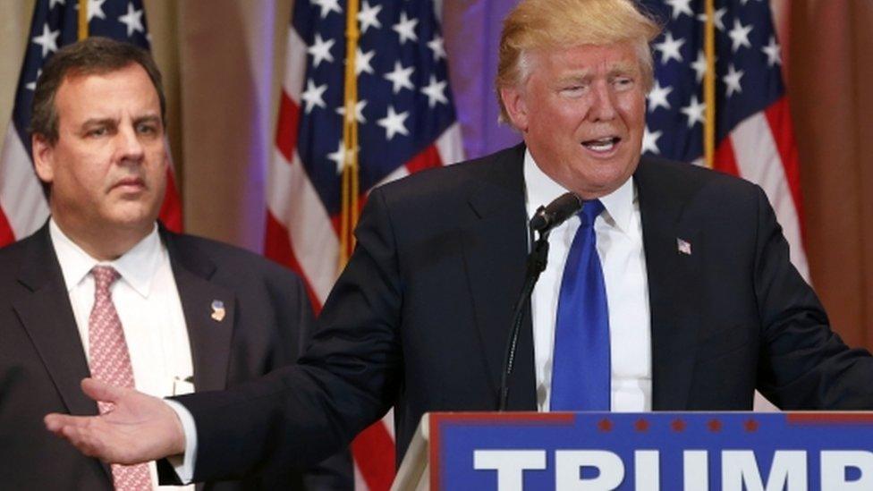 New Jersey Governor Chris Christie (left) listens as Republican presidential candidate Donald Trump (right) speaks to the media during a campaign event on 1 March 2016 in Palm Beach, Florida