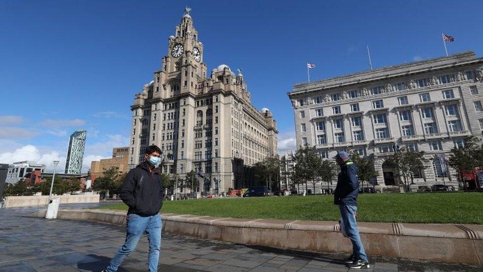 People in masks at Liverpool waterfront