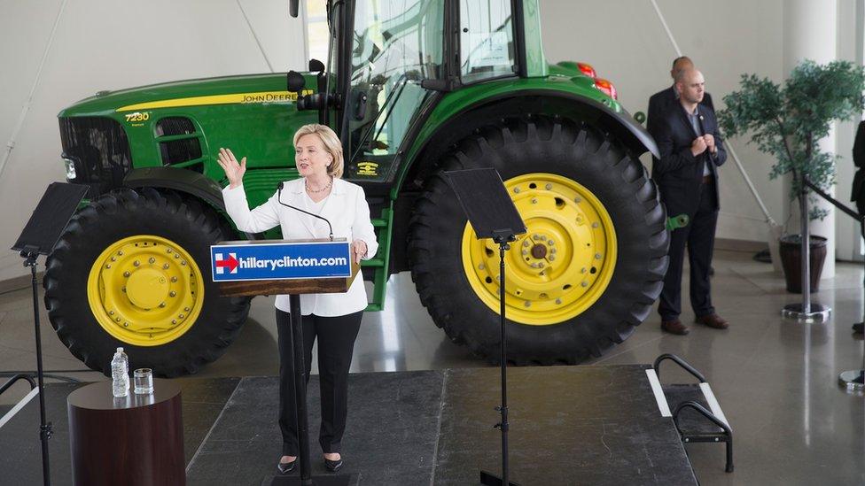 Hillary Clinton speaks in front of a tractor