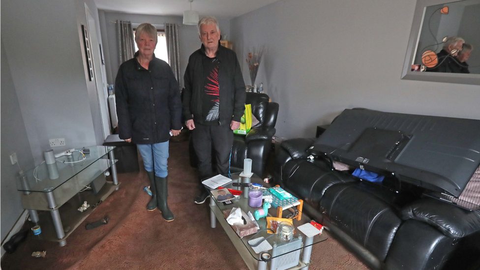 Jean Hendrie and William Craik cleaning their house in Pyothall Court in Broxburn, West Lothian after flooding.