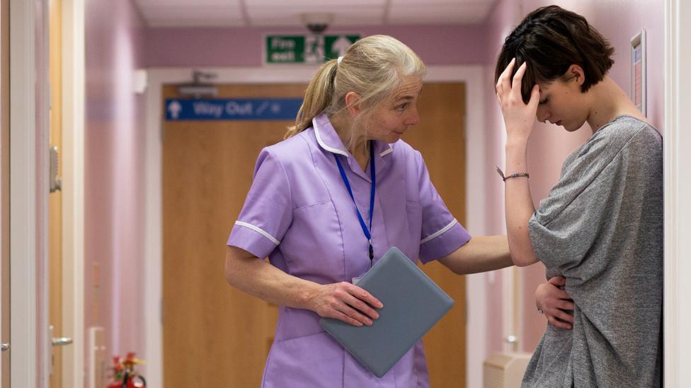 Nurse comforts a woman