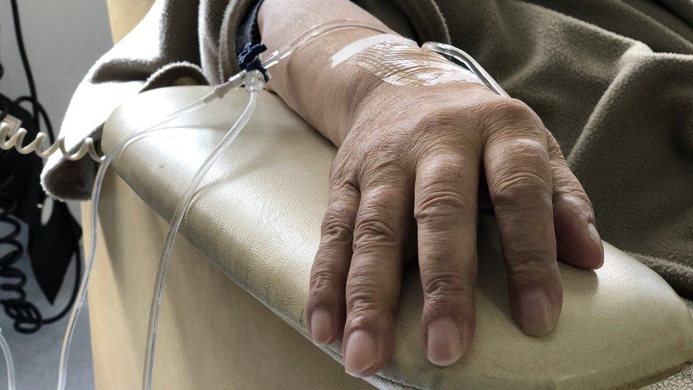 A female patient receives chemotherapy treatment for cancer