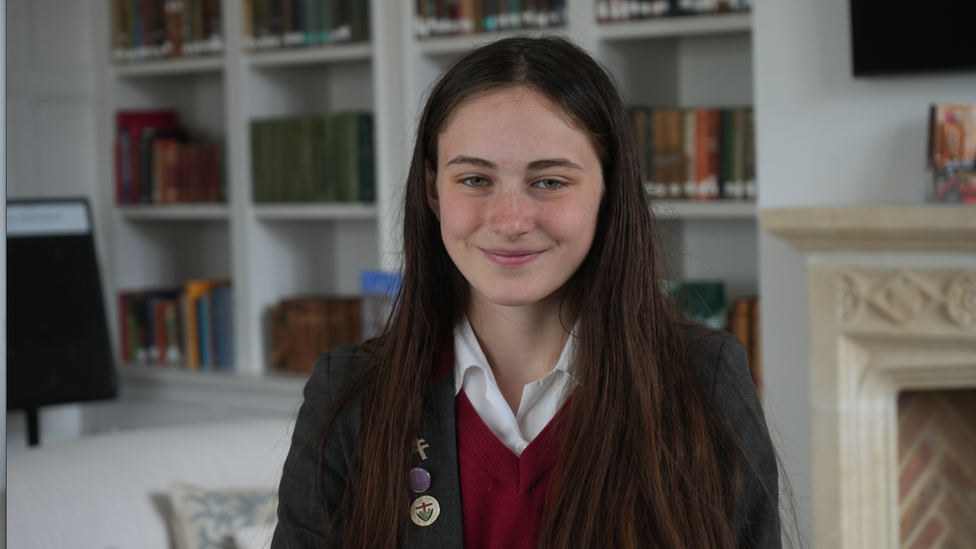 School pupil Isabel sitting in school library