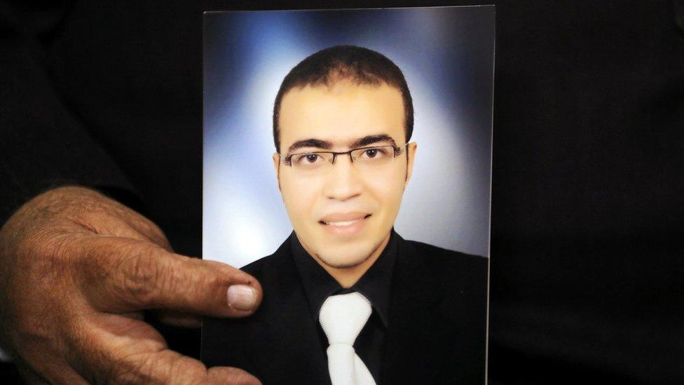 Reda al-Hamamy, the father of Abdullah al-Hamamy who is suspected of attacking a soldier in Paris's Louvre museum, holds a picture of his son during an interview with Reuters in Daqahliya, Egypt, 4 February