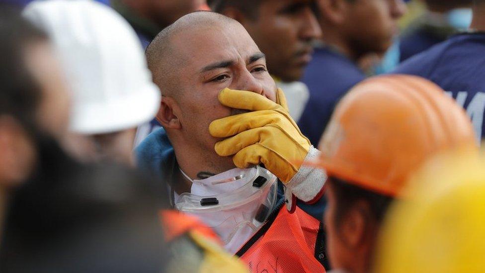 Members from the rescue services stay outdoors as new earthquake hit Mexico City