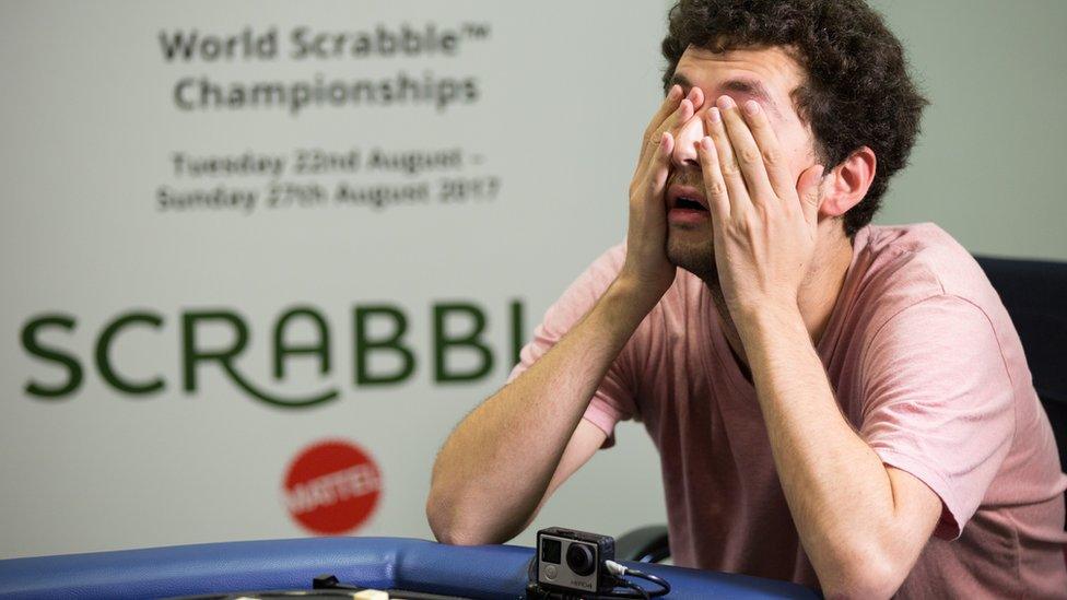 David Eldar covers his eyes playing scrabble