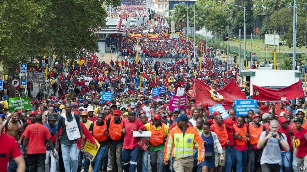 Thousands of protesters march through Johannesburg on March 7, 2012 to protest new tolls on highways between Johannesburg and nearby Pretoria and the practices of temp agencies, which unions say are hurting the poor.