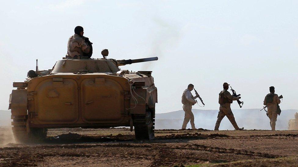 Iraqi forces advance in the village of Badoush, some 15km northwest of Mosul, during the battle to retake the city's west from so-called Islamic State (IS), 7 March 2017