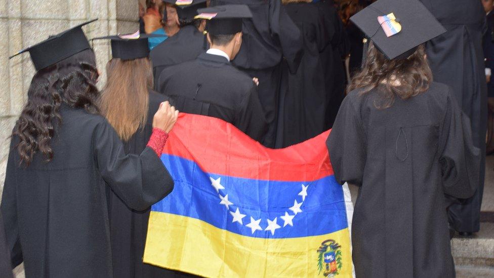 Students carry an upside-down flag at a graduation ceremony in Mérida