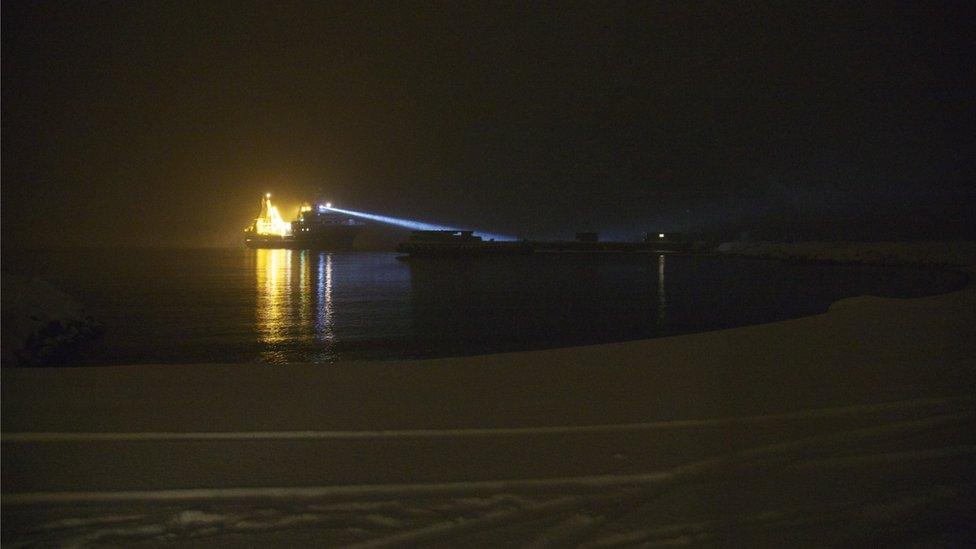 Research boat lit up in the darkness