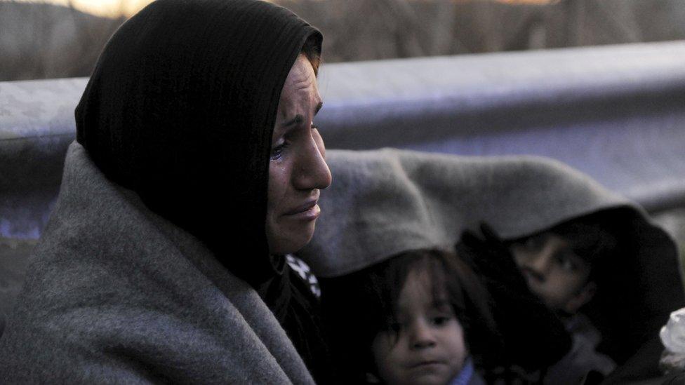 Mother and children from Afghanistan wait near Idomeni while trying to reach Macedonian border