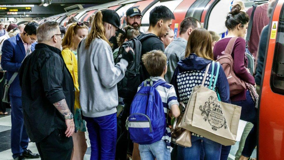 Passengers board crowded Tube