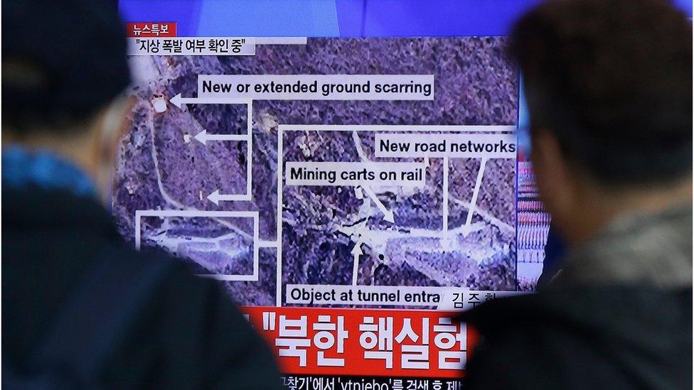 People look at a screen showing news of the nuclear test, outside a train station in Seoul