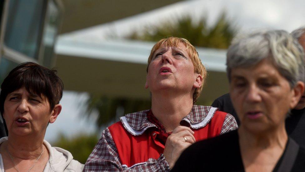 people looking to the sky and praying