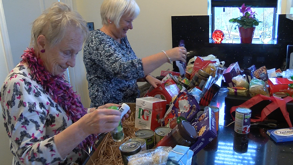 Volunteers pack welcome boxes for Syrian refugees