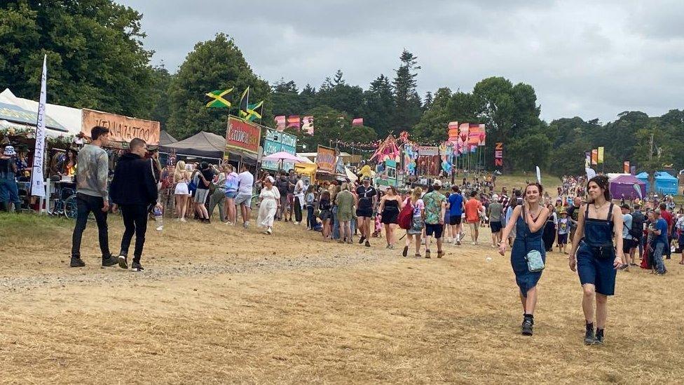 People milling around stalls at Latitude festival