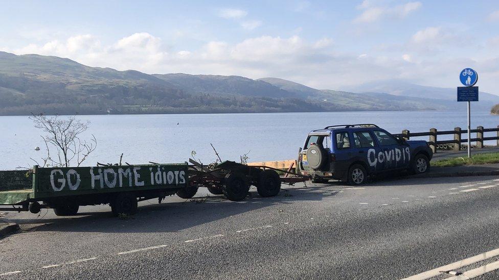 sign on a trail says "Go home idiots"