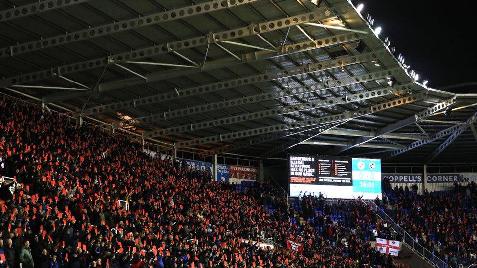 Reading fans protest holding red cards in protest against Port Vale in February