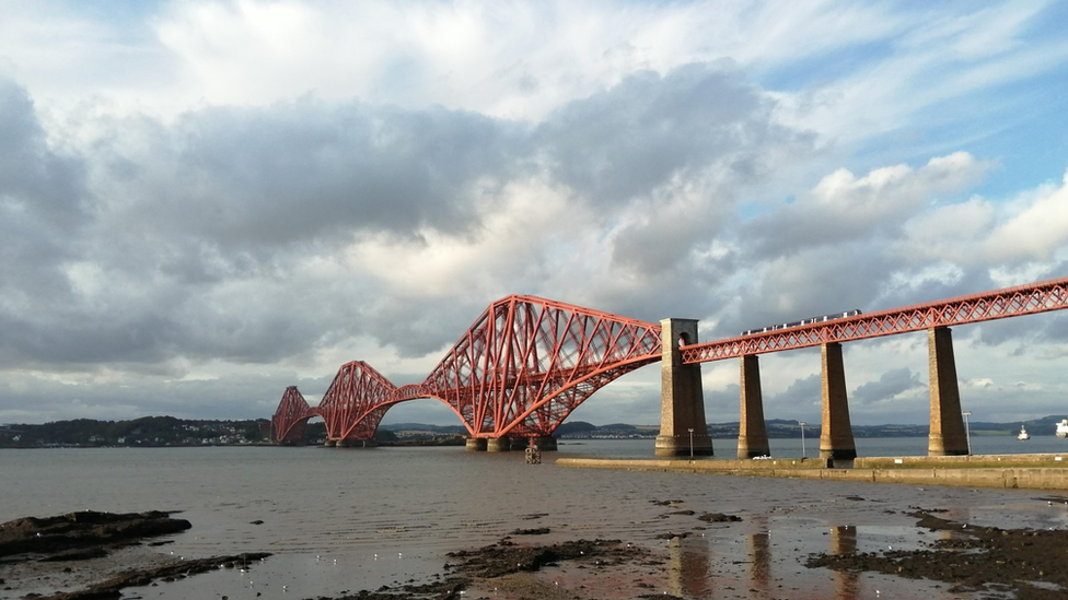 Queensferry bridge stretching out into the distance with fair weather cloud and some sunny spells.