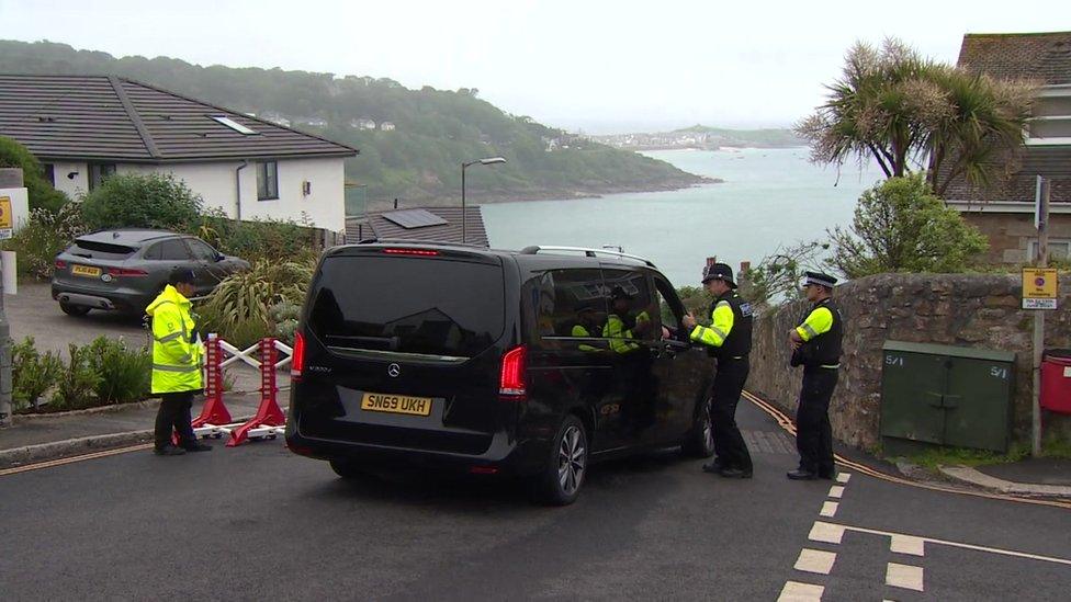 Police officers checking a car