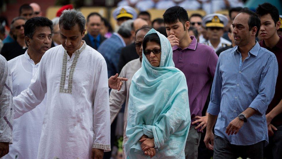 Family members of a Bangladeshi policeman mourn his death during a memorial service for those killed in a bloody attack and siege in Dhaka on July 4, 2016.