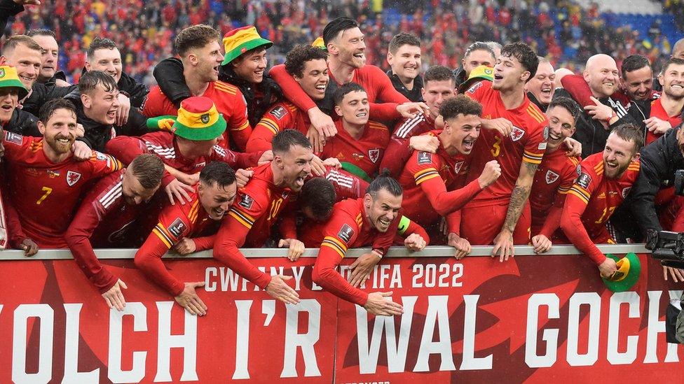 Wales players celebrate after qualifying for the World Cup