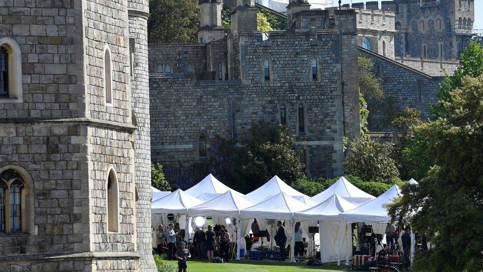 Television crews report from the scene at Windsor Castle before the upcoming wedding