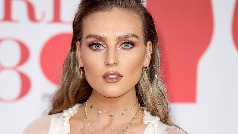 Perrie Edwards at an event, wearing makeup which covers up her freckles.