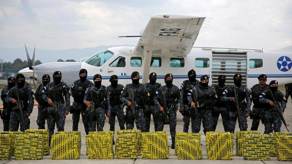 Police stand in front of seized cocaine in Guatemala City